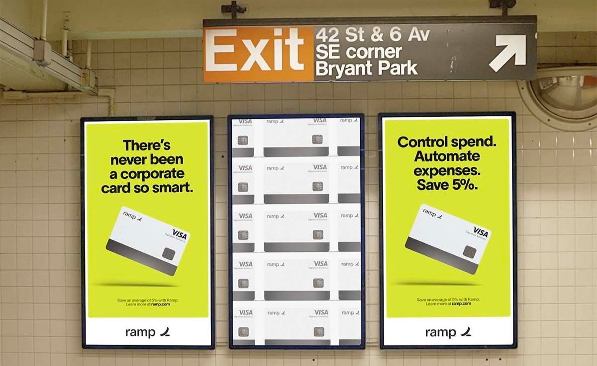 Ramp corporate-card subway advertisements at a New York City station.